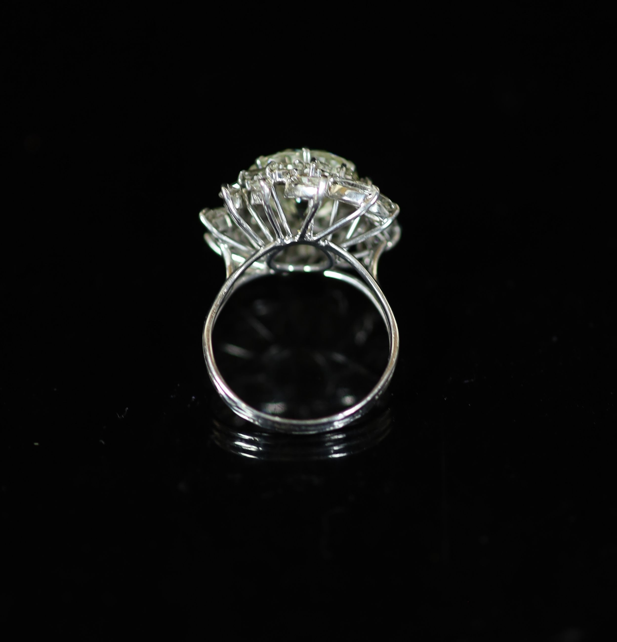 A platinum and single stone diamond ring, with baguette and marquise cut diamond foliate setting